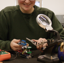 Student using a soldering station